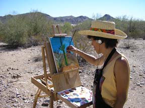 Artist Angie Young painting in the Arizona desert